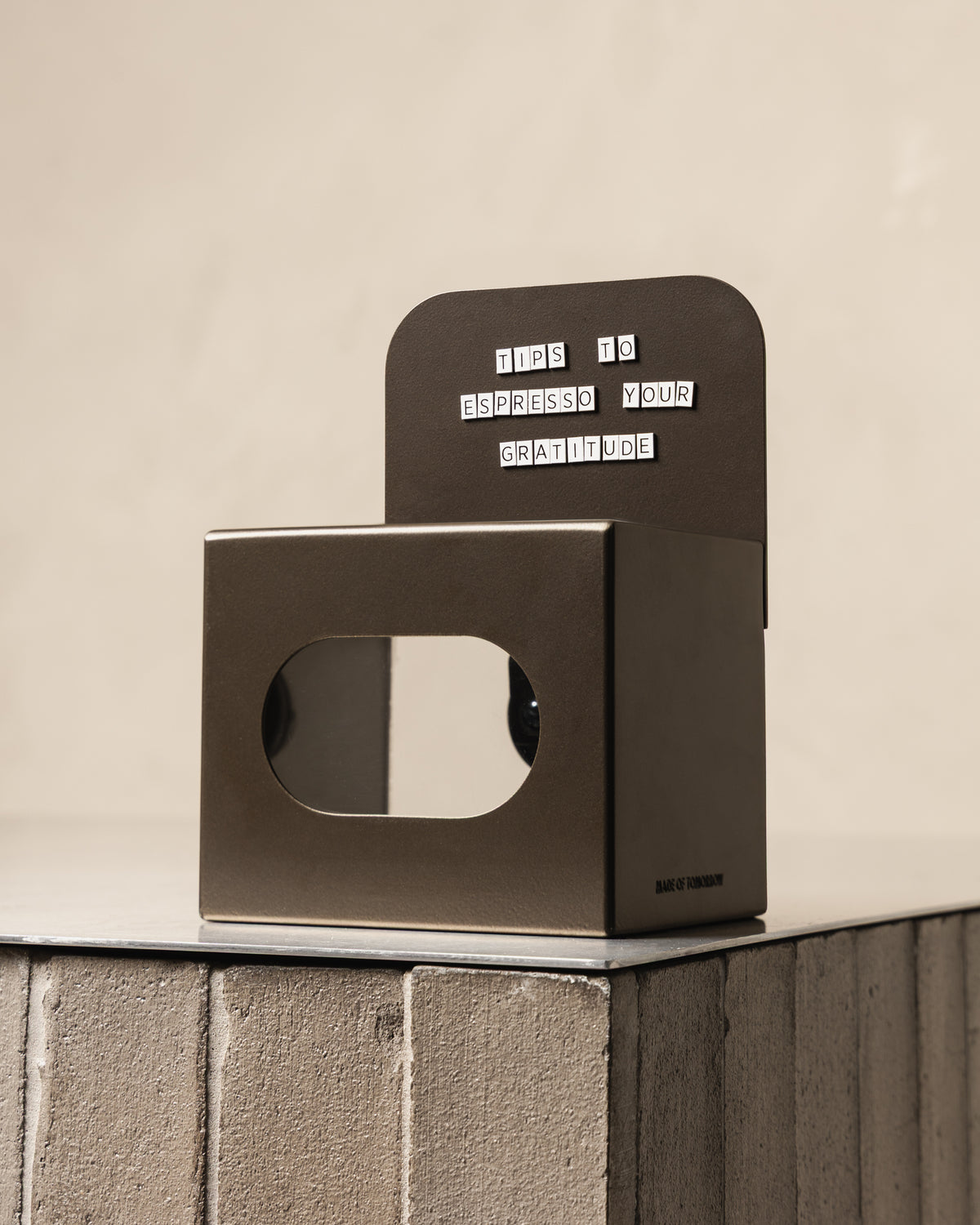 Bronze FOLD Tip Box with a magnetic message displayed on a tiled counter